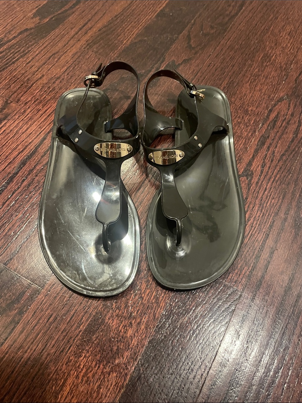 Michael Kors black jelly thong sandals with gold logo